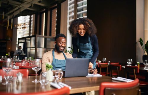 man and woman doing computer work in Hospitality venue