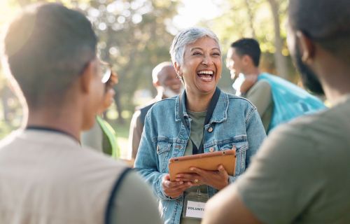 lady in park holding a clipboard