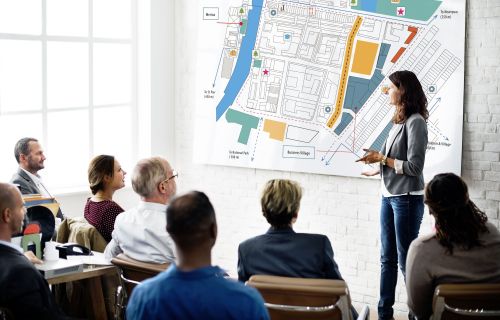 person presenting plans to a group