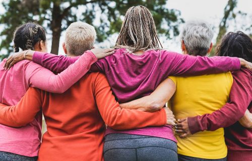 Five diverse women united, arm in arm