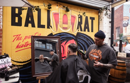 image taken in hop lane in front of the ballarat mural of a barber and a person infront of a mirror