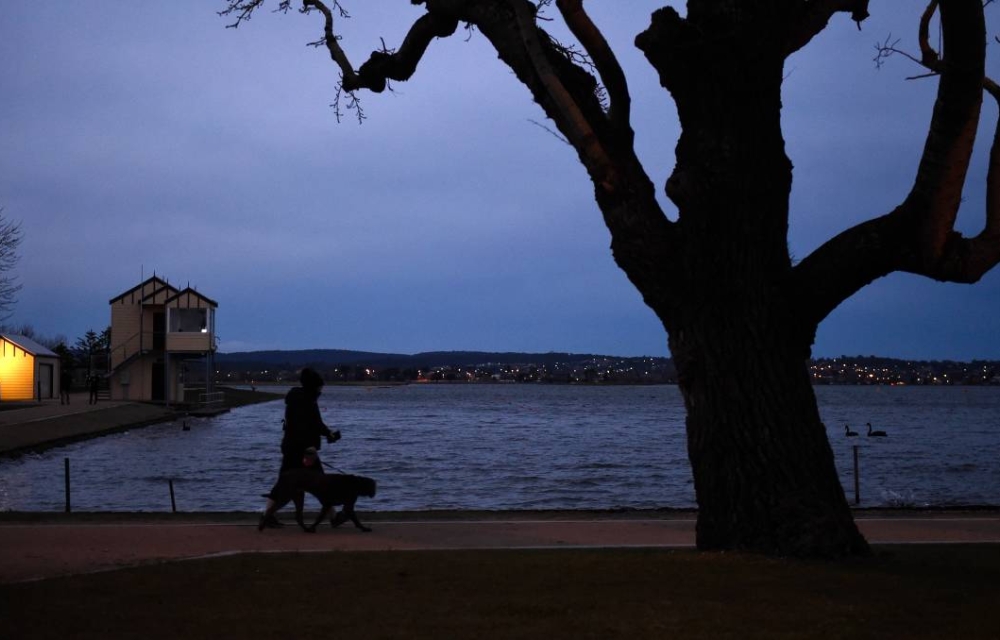 Lake Wendouree in the pre=dawn light with a silhouette of a person walking a dog