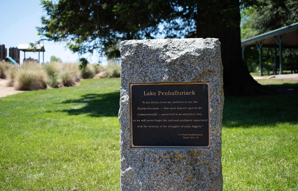 A plaque on a stone pillar in a park