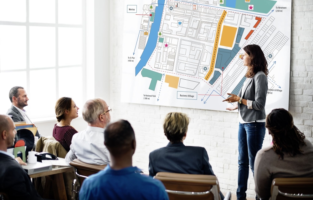 person presenting plans to a group
