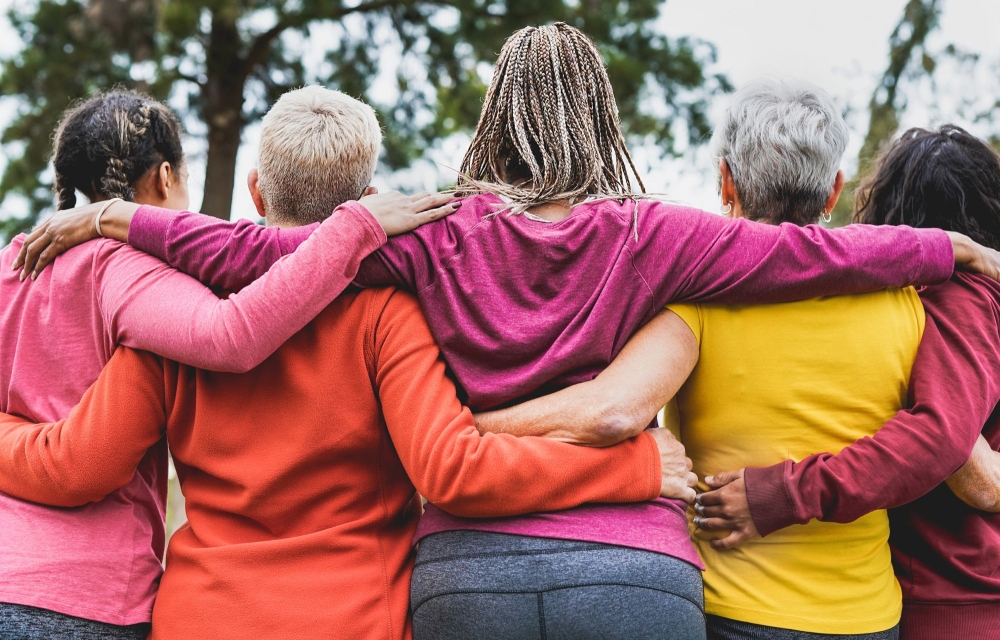 Five diverse women united, arm in arm