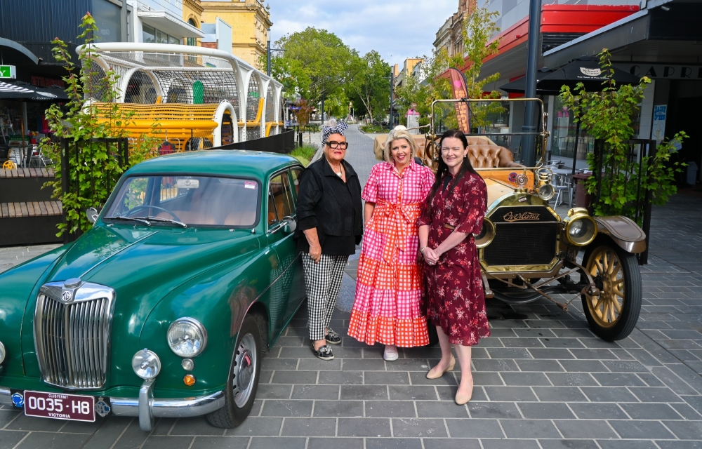Image of the Bridge Mall with two vintage cars, two shop owners and the Mayor of Ballarat