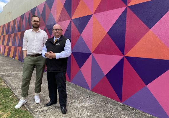 Generic image of Spencer Harrison and Mr Mayor in front of a colourful wall
