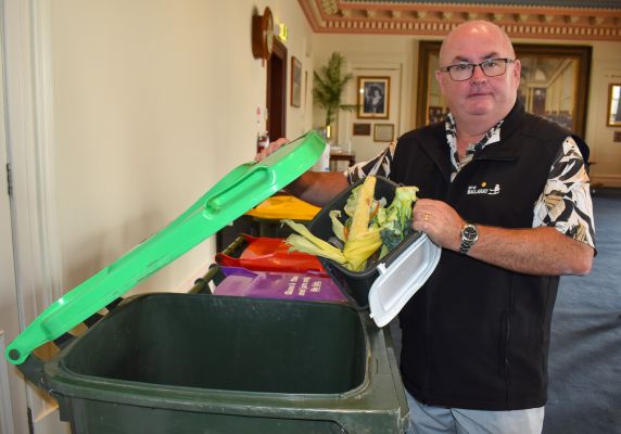 Mayor Des Hudson holding FOGO waste