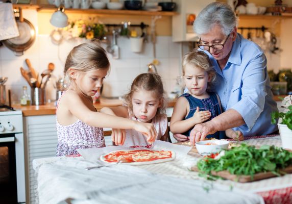 A grandmother baking with her grandchildren.