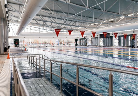 In the foreground is a walkway into a pool and in the background is the pool.