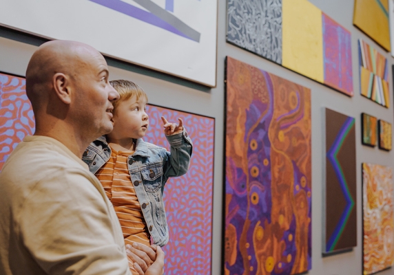 A man and young child looking at artwork in the Art Gallery of Ballarat.