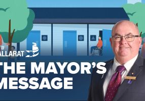 Text with The Mayor's Message with an image of Mayor Cr Des Hudson in front of public toilet image
