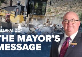 Text with The Mayor's Message with an image of Mayor Cr Des Hudson in front of a tip