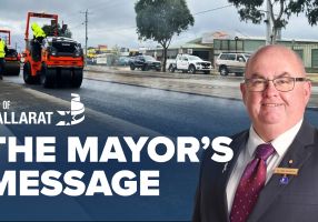 Text with The Mayor's Message with an image of Mayor Cr Des Hudson in front of an image of road resurfacing works