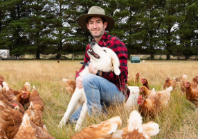Joel Owins and his Maremma dog Nugget. Joel’s family-owned business, White Swan Free Range Eggs, is feeding our local food industry.