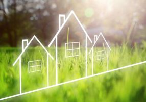 Outline of houses with green grass