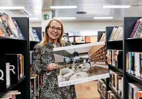 woman holding artist's impression of new library