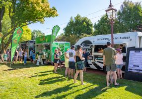Customers being served by food trucks