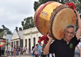 Image of a Chinese man carrying a drum