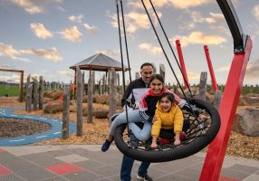 a family on a swing in a playground