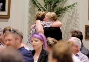 two people hugging in a crowd 