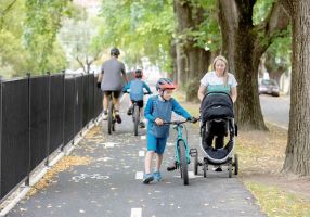 Families using a shared path with bikes and a pram