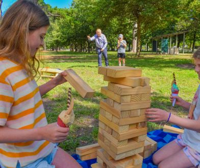 Picnic in the park activities including giant jenga and corn hole